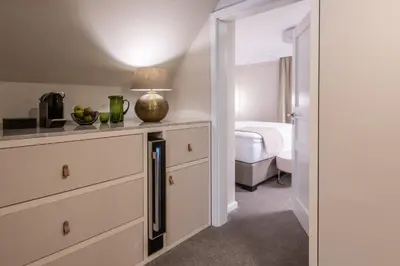 a bedroom with a bed and a table with a lamp at Mamma´s Boutique Hotel in Poděbrady