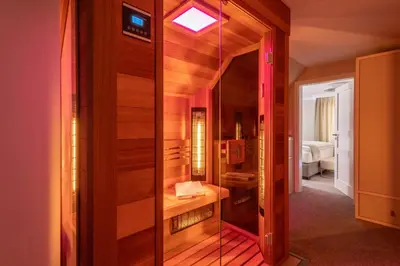 a bathroom with a mirror and a room with a bed at Mamma´s Boutique Hotel in Poděbrady