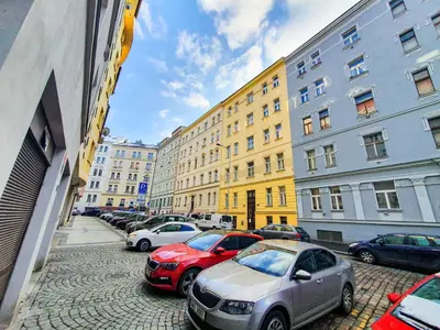 a group of cars parked on a street with buildings at Apartment in the center of Prague in Prague