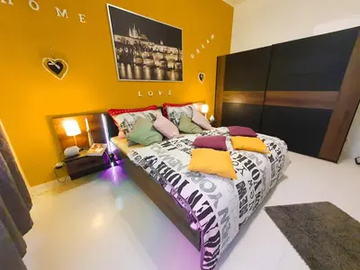 a bedroom with a large bed with colorful pillows at Apartment in the center of Prague in Prague