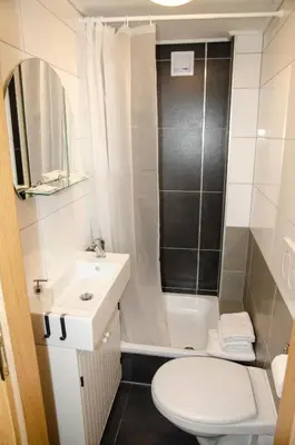 a bathroom with a toilet and a sink and a shower at The Republic Apartments in Prague