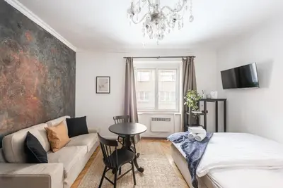a living room with a couch and a table at Crystal Apartment in Prague
