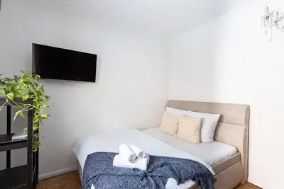 a bedroom with a bed and a flat screen tv at Crystal Apartment in Prague