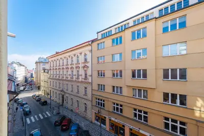 an apartment building in a city with cars parked on a street at Crystal Apartment in Prague