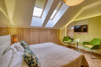 a bedroom with a bed and a flat screen tv at Salvator Boutique Hotel vegan-friendly in Prague