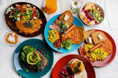 a table with plates of food on it at Salvator Boutique Hotel vegan-friendly in Prague