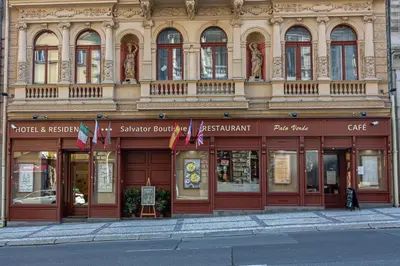 a building on a street with flags in front of it at Salvator Boutique Hotel vegan-friendly in Prague