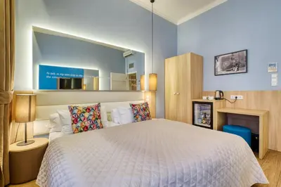 a bedroom with a large bed with a large mirror at Salvator Boutique Hotel vegan-friendly in Prague