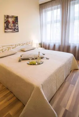 a bed with a plate of food on top of it at Apartment Za Poricskou branou in Prague