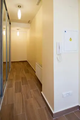 an empty hallway with wood floors and a wall at Apartment Za Poricskou branou in Prague