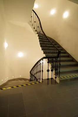 a staircase with black railings in a house at Apartment Za Poricskou branou in Prague