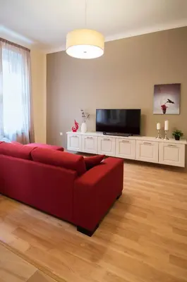 a living room with a red couch and a flat screen tv at Apartment Za Poricskou branou in Prague