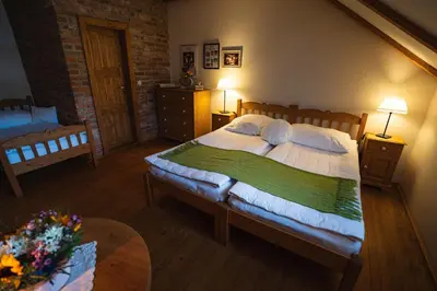 a bedroom with a large bed and a table at Starý Svět in Wotitz