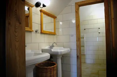 a white bathroom with a sink and a mirror at Starý Svět in Wotitz
