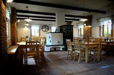 a kitchen and dining room with tables and chairs at Starý Svět in Wotitz