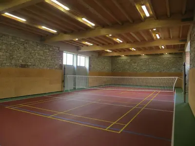 a tennis court with a net in a room at Agropenzion U Bartousku in Malíkovice