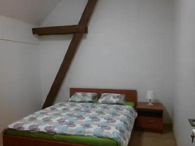 a bedroom with a bed with a wooden frame at Agropenzion U Bartousku in Malíkovice