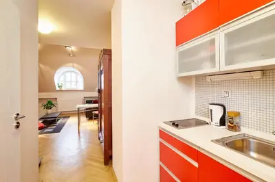 a kitchen with orange cabinets and a sink at Prague Letna Apartments in Prague