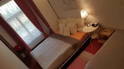 a small bed in a small room with a window at Family Flat 120m2, Praha 2 Vinohrady in Prague