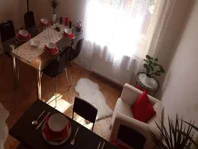 a living room with a table and a white couch at Family Flat 120m2, Praha 2 Vinohrady in Prague