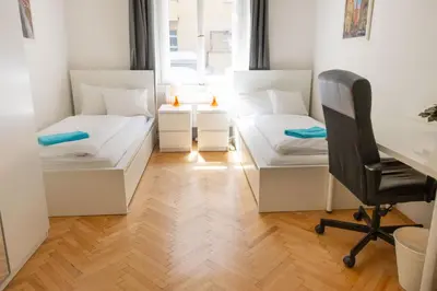 a room with two beds and a desk and a chair at Apartments with 2 Bathrooms- 5 minutes from Old Town - 102 m2 in Prague