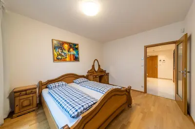 a bedroom with a bed and a picture on the wall at Garden Towers Apartments in Prague