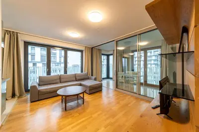 a living room with a couch and a table at Garden Towers Apartments in Prague