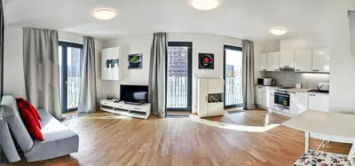 a living room with a couch and a kitchen at Garden Towers Apartments in Prague