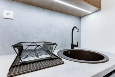 a black sink on a counter with a faucet at Apartment Petrska in Prague