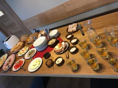 a table topped with plates of food and glasses of wine at Penzion v Zálesí in Mladá Boleslav