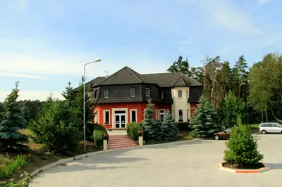 a red and white house with a driveway at Penzion v Zálesí in Mladá Boleslav