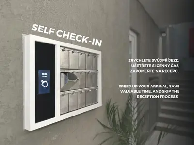 a window with a self check in sign on a wall at Hotel AMITY in Prague