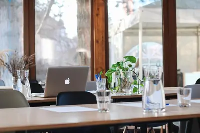 a table with a laptop computer on top of it at Hotel AMITY in Prague