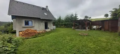 a house with a yard next to a building at Chata u rybníka in Mšecké Žehrovice