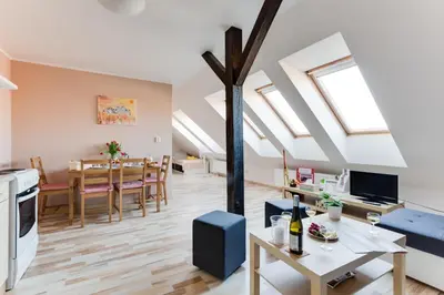 a living room and dining room with skylights at Jane's Attic Apartment in Prague