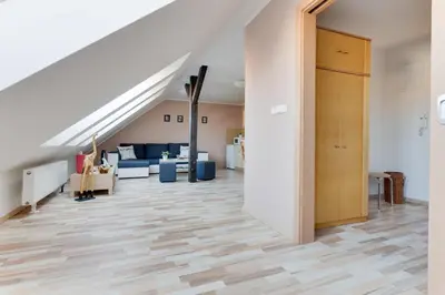 an open hallway with a staircase with a living room at Jane's Attic Apartment in Prague