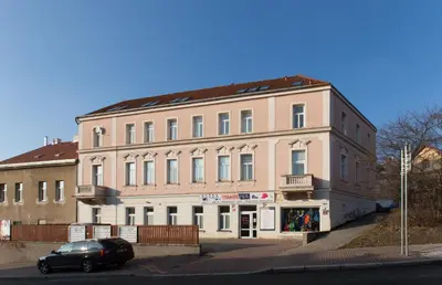 a large building with a car parked in front of it at Jane's Attic Apartment in Prague