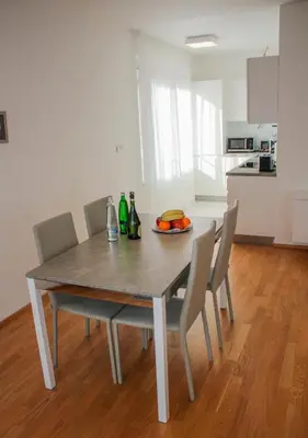 a dining table and chairs with bottles and fruit on it at Rezidence Muzeum in Prague