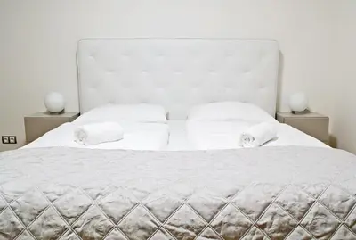 a bedroom with a large white bed with two night stands at Rezidence Muzeum in Prague