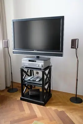 a flat screen tv on a black stand with a television at Pawlansky Prague Apartments in Prague