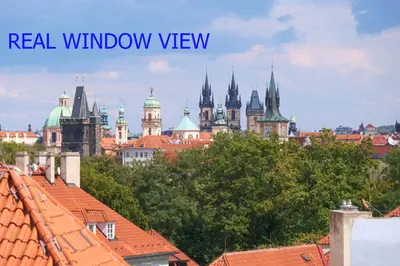a view of the roofs of a city with buildings at Pawlansky Prague Apartments in Prague
