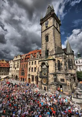 a large crowd of people in front of a building with a clock tower at Pawlansky Prague Apartments in Prague