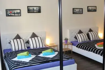 a bedroom with two beds with pillows at Go Native Prague Apartment in Prague
