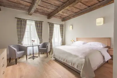 a living room with a couch and a table at Hotel At the White Lily in Prague