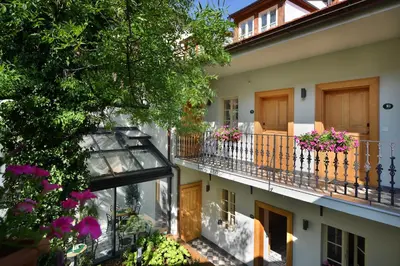 a house with two flower pots on a balcony at Hotel At the White Lily in Prague