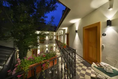a restaurant with tables and chairs in a courtyard at Hotel At the White Lily in Prague