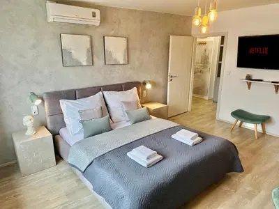 a bedroom with a large bed with two towels on it at Beautiful Apartment Dlouhá in Prague