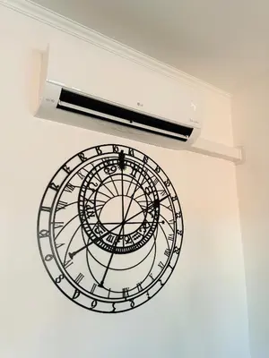 a clock hanging from a ceiling with a wand at Beautiful Apartment Dlouhá in Prague