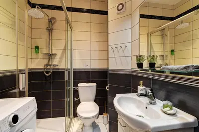 a bathroom with a toilet and a sink at Beautiful Apartment Dlouhá in Prague