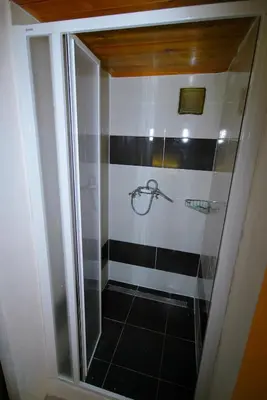 a shower with black and white stripes in a bathroom at Apartments Zbraslav in Prague